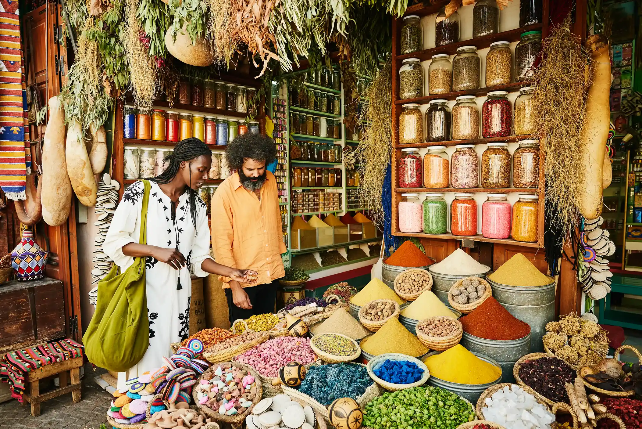 Couple shopping for spices at the Marrakech Souk.
